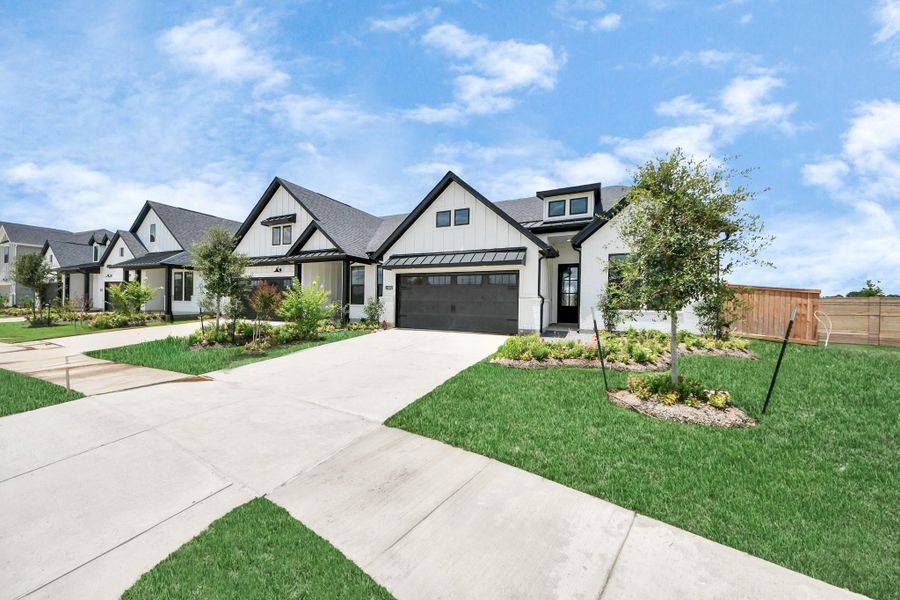 Front exterior of a new home in Bridgeland: Signature Collection, Cypress, TX, highlighting curb appeal (Image 19). Front exterior of a new home in Bridgeland: Signature Collection, Cypress, TX, highlighting curb appeal (Image 19).