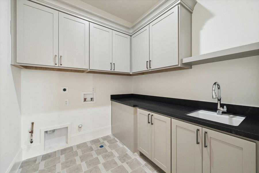 Utility room included on the second floor with plenty of built-in storage, along with Kohler Park Falls enameled cast iron undermount utility sink and Kohler Simplice compact faucet.