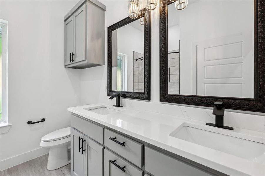 Hall bath with double sinks and custom cabinets