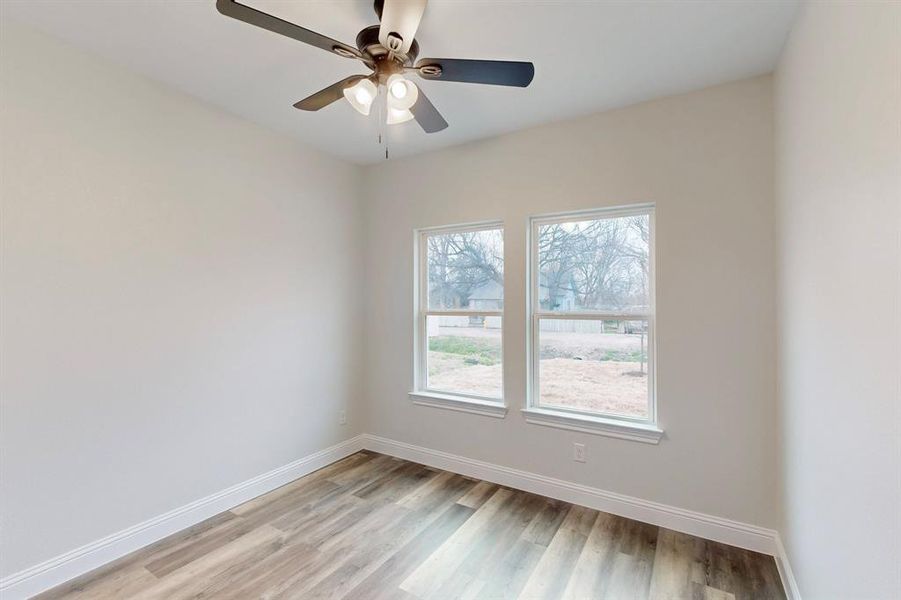 Spare room with ceiling fan and light wood-type flooring