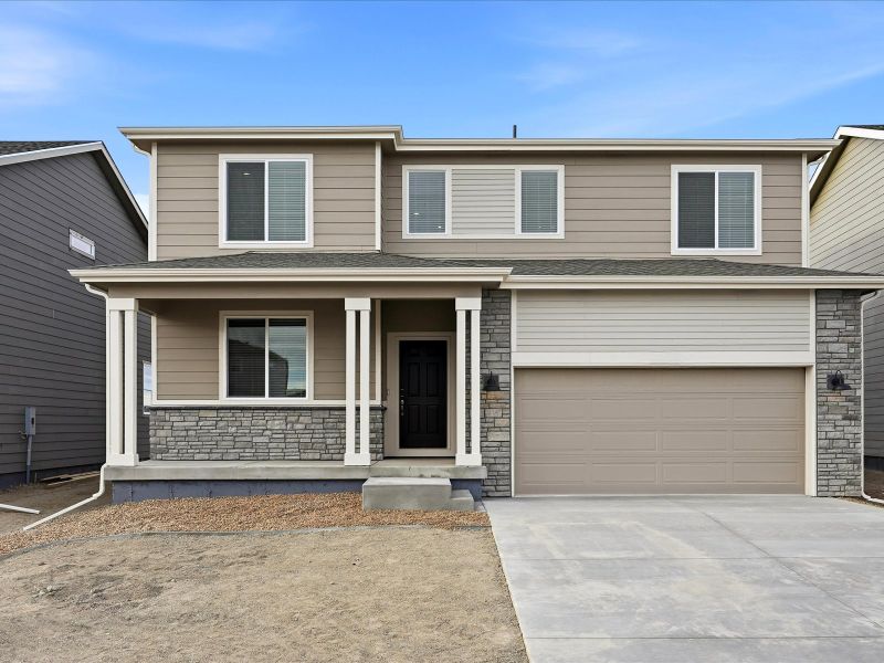 Front exterior of a new home in Meridian Ranch, Peyton, CO, highlighting curb appeal (Image 1). Front exterior of a new home in Meridian Ranch, Peyton, CO, highlighting curb appeal (Image 1).