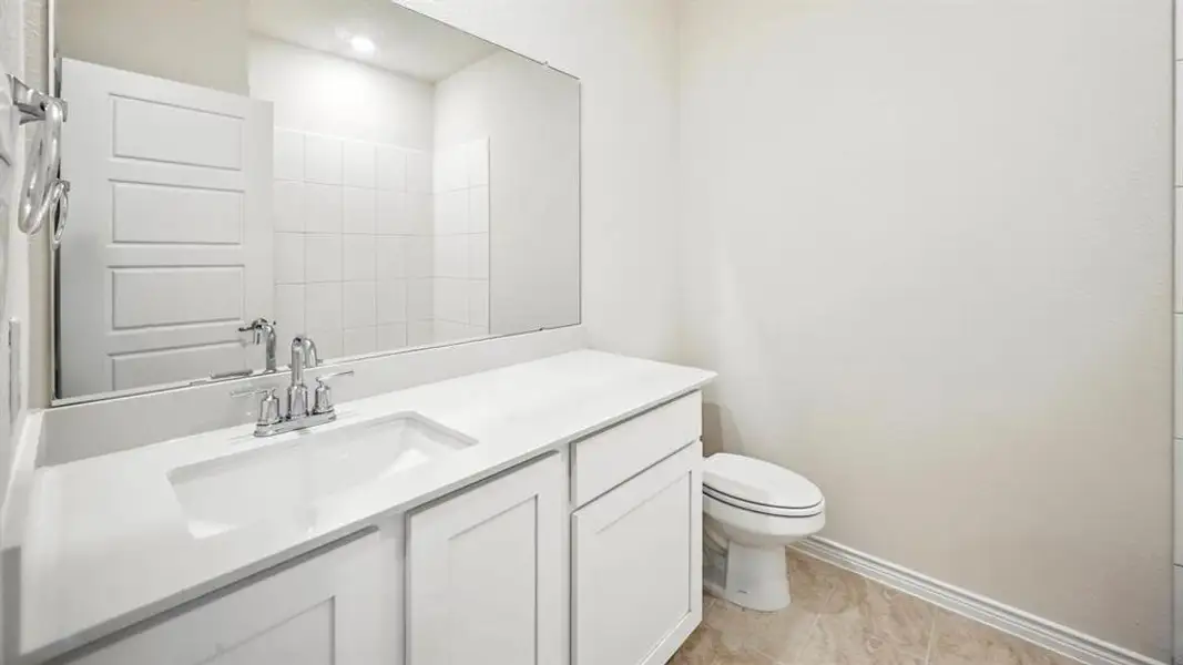 Bathroom vanity with an integrated sink, polished chrome faucet, and spacious countertop