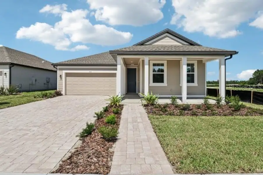 Front exterior of a new home in Ardisia Park, New Smyrna Beach, FL, highlighting curb appeal (Image 20).