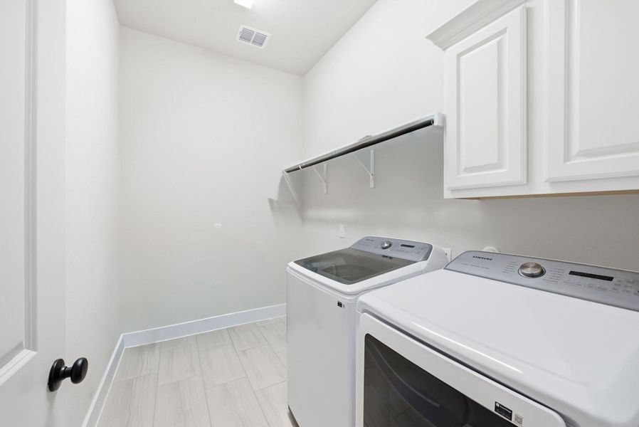The laundry room provides ample space for 2 full sized units and a space to hang clothes