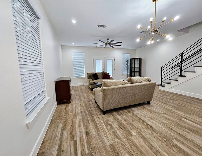 Living room with dining room area. Double doors lead to backyard.