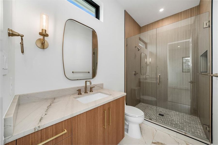 Full bath with a stall shower, vanity, and light marble finish floors Full bath with a stall shower, vanity, and light marble finish floors