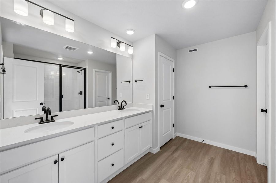 A bathroom with white cabinets.