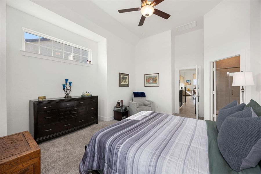 Alternate view of the primary bedroom demonstrates its size and a separate seating area.