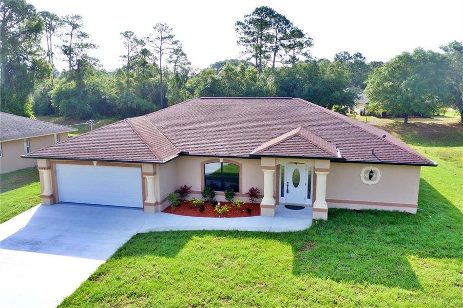 Front exterior of a new home in , North Port, FL, highlighting curb appeal (Image 1).
