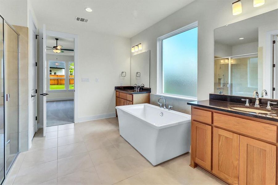 Freestanding soaking tub with a large frosted window Freestanding soaking tub with a large frosted window