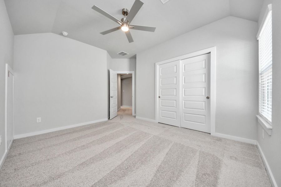 Generously sized secondary bedrooms featuring spacious closets, soft and inviting carpeting underfoot, large windows allowing plenty of natural light, and the added touch of privacy blinds for your personal retreat.