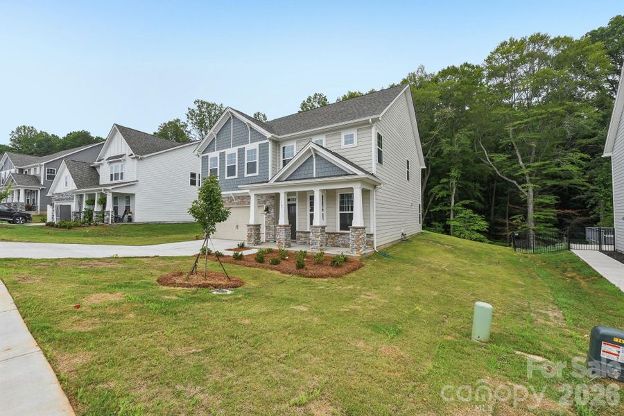 Front exterior of a new home in Falls Cove, Troutman, NC, highlighting curb appeal (Image 1). Front exterior of a new home in Falls Cove, Troutman, NC, highlighting curb appeal (Image 1).