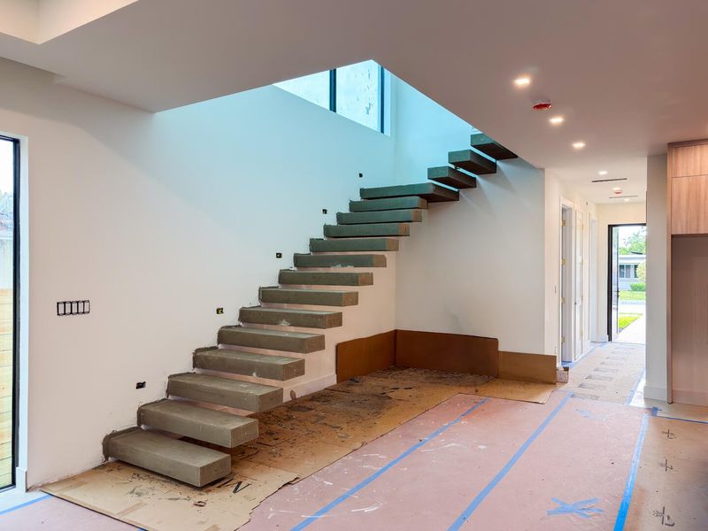 (as of April 8, 2026) the space beneath the floating concrete stairs are ideal for a dry bar, seating area, or wine showcase.