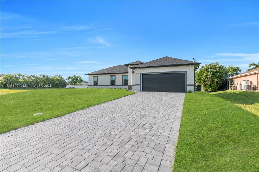 Front exterior of a new home in , Cape Coral, FL, highlighting curb appeal (Image 1). Front exterior of a new home in , Cape Coral, FL, highlighting curb appeal (Image 1).