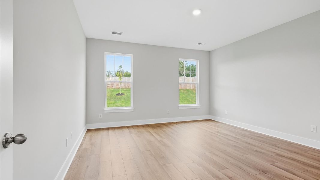 Eye-catching details and elegant finishes in the vibrant primary suite of this select home