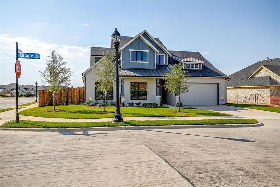 View of front of home with a front yard and a garage