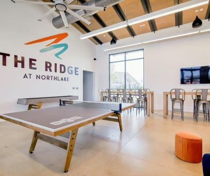 Recreation room featuring high vaulted ceiling, beam ceiling, and a ceiling fan