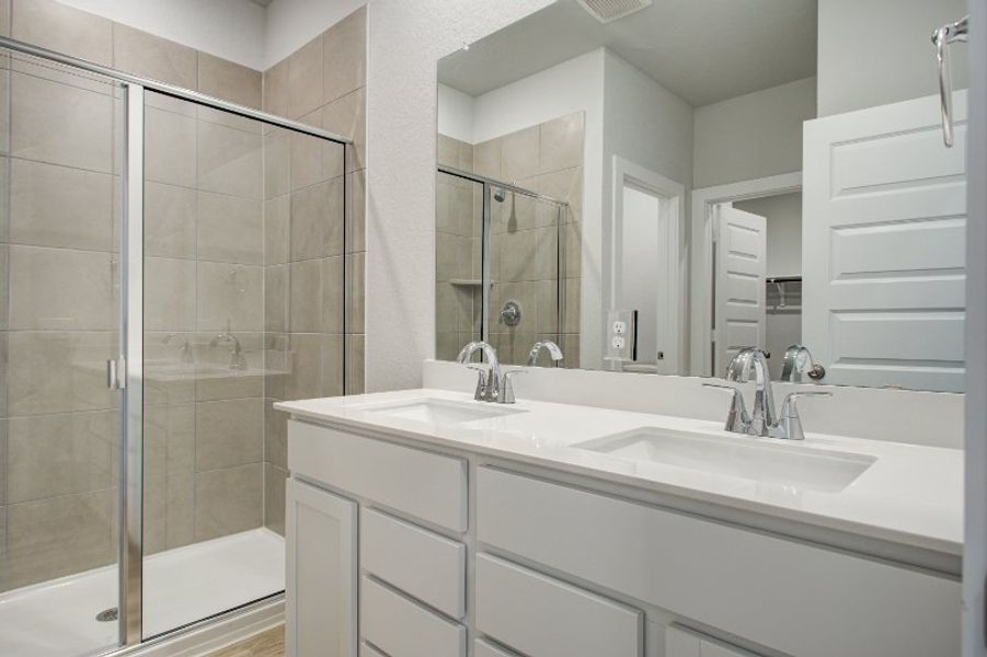 A bathroom with a glass shower. A bathroom with a glass shower.