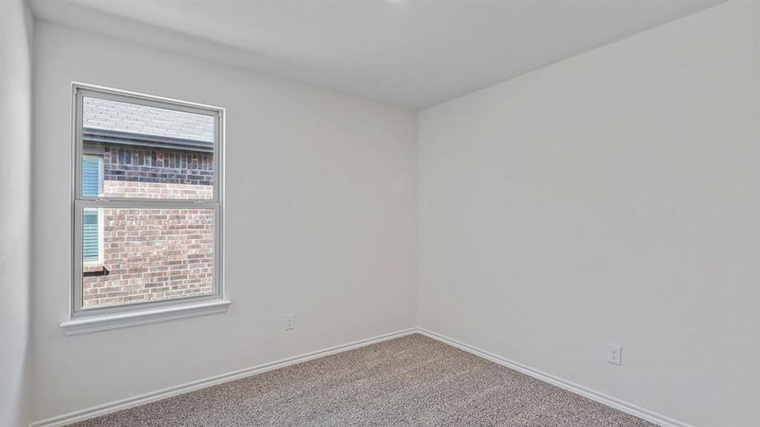 Empty room featuring baseboards and carpet flooring Empty room featuring baseboards and carpet flooring