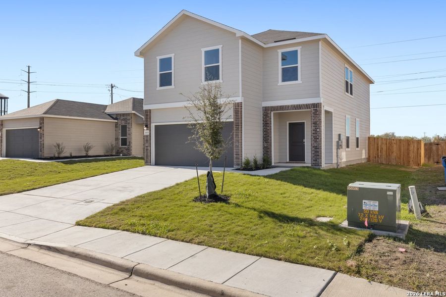 Front exterior of a new home in Woodside Farms, Seguin, TX, highlighting curb appeal (Image 18). Front exterior of a new home in Woodside Farms, Seguin, TX, highlighting curb appeal (Image 18).