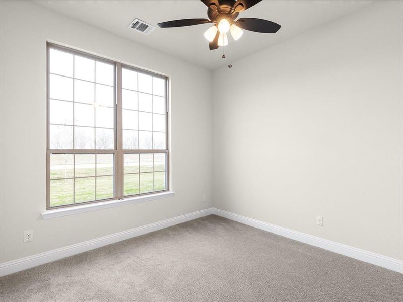 Spare room featuring light carpet and ceiling fan