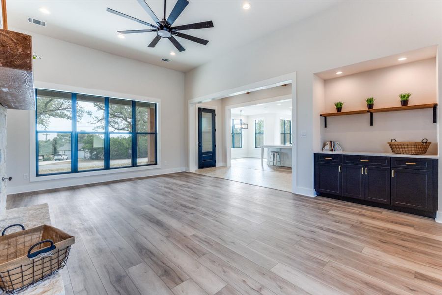 Unfurnished living room with ceiling fan, recessed lighting, and light wood-style floors
