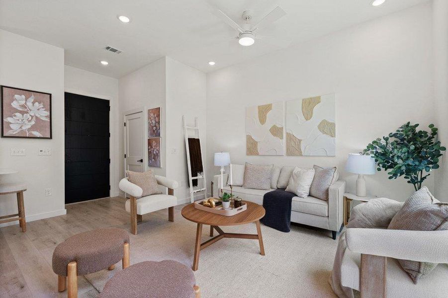 Living space featuring light-colored flooring, recessed lighting, and a ceiling fan