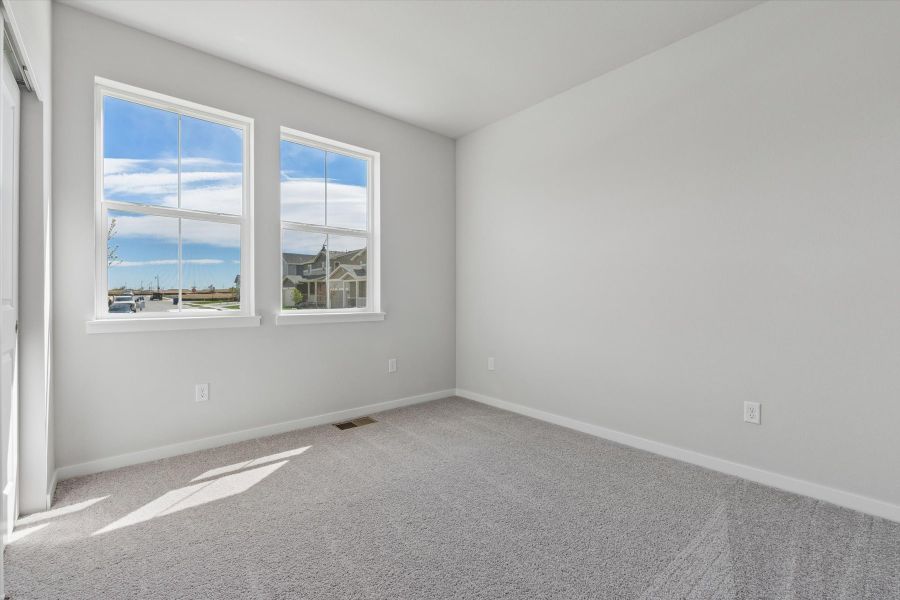 A room with a window and a carpet. A room with a window and a carpet.