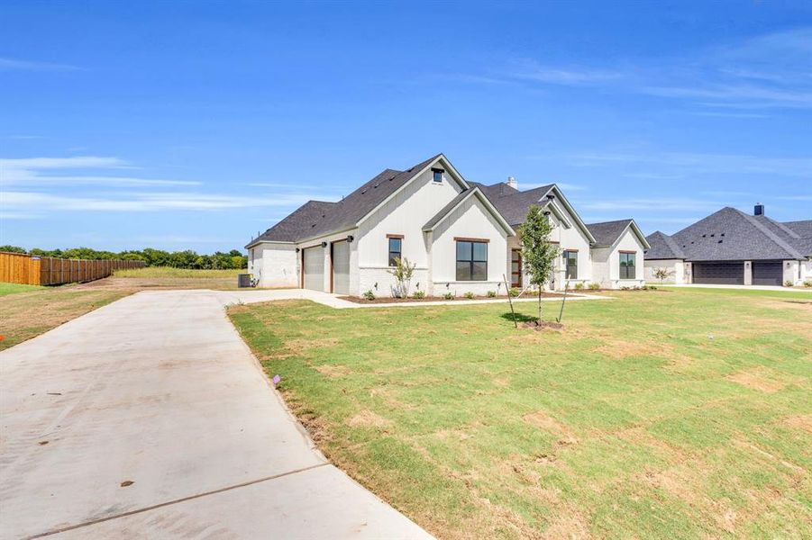 Front exterior of a new home in , Waxahachie, TX, highlighting curb appeal (Image 1).