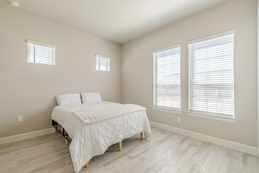 Bedroom featuring light wood-type flooring and baseboards