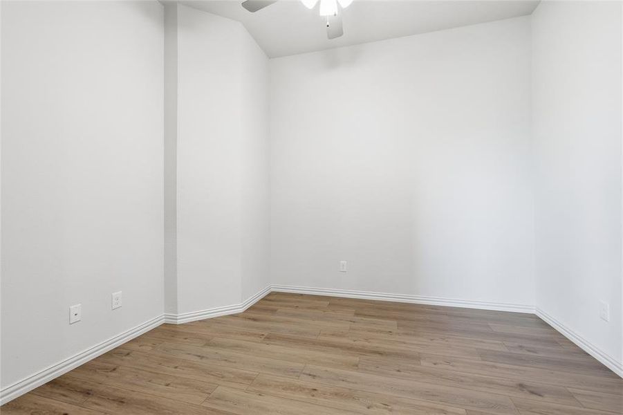 Spare room featuring light wood-style floors and a ceiling fan
