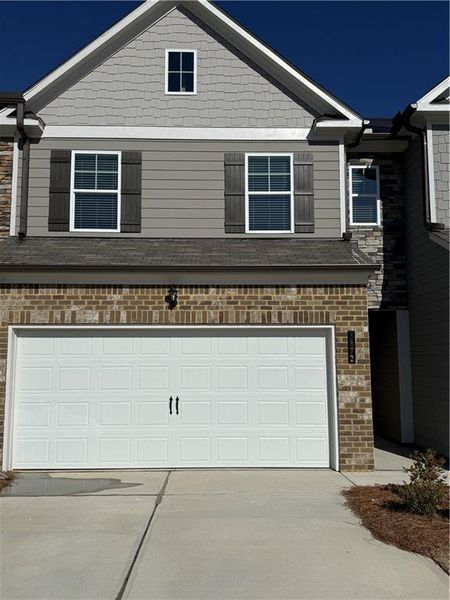 Front exterior of a new home in Somerset at Riverbrook, Gainesville, GA, highlighting curb appeal (Image 1). Front exterior of a new home in Somerset at Riverbrook, Gainesville, GA, highlighting curb appeal (Image 1).
