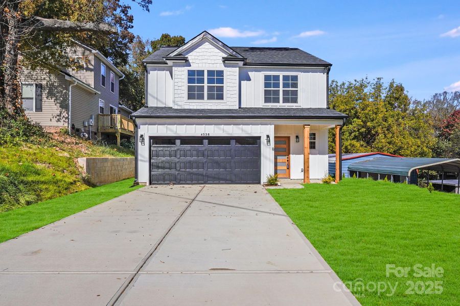 Front exterior of a new home in , Concord, NC, highlighting curb appeal (Image 1).