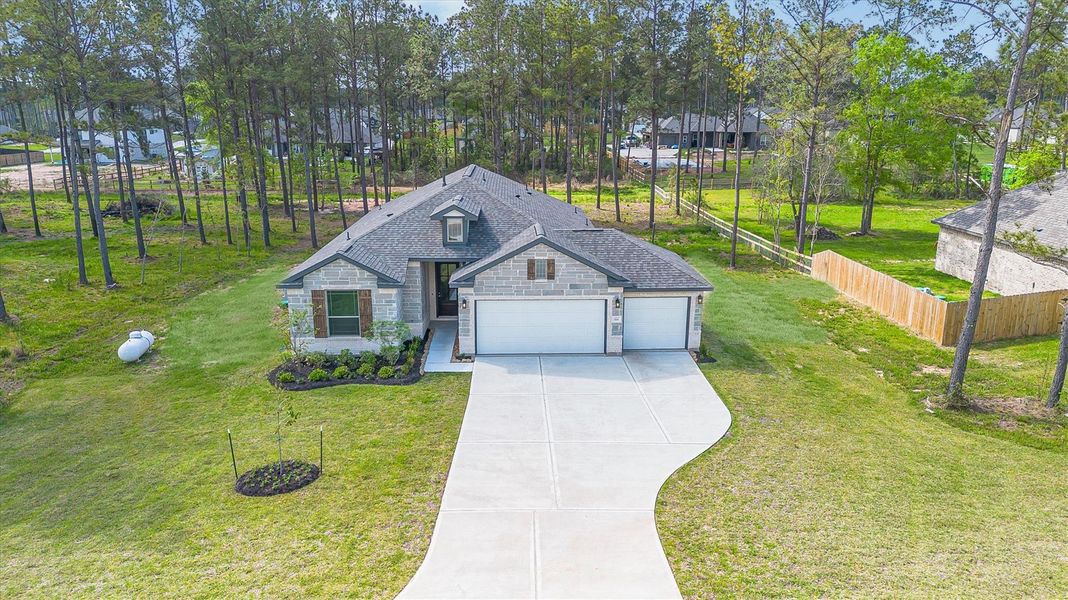 Front exterior of a new home in Deer Pines, Conroe, TX, highlighting curb appeal (Image 21).
