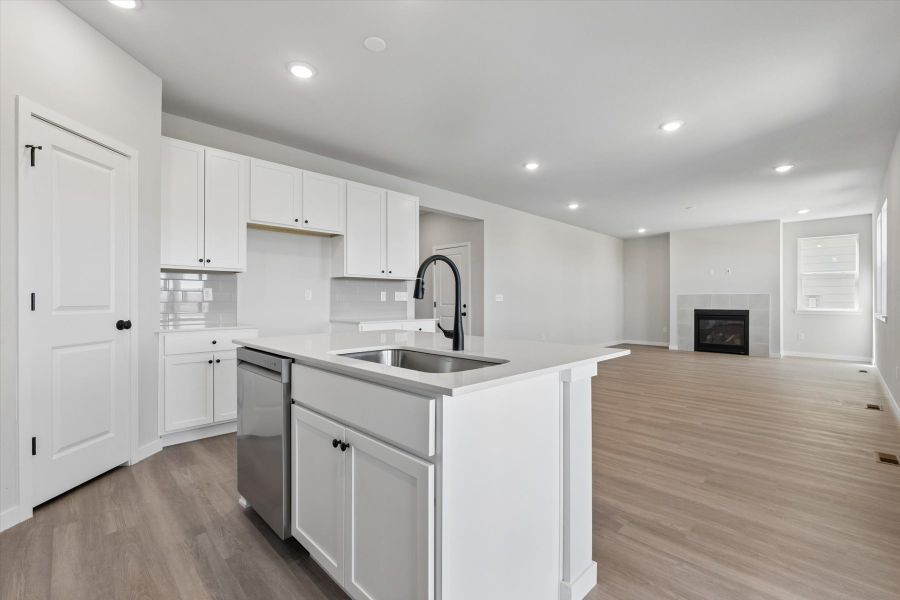 A kitchen with white cabinets.