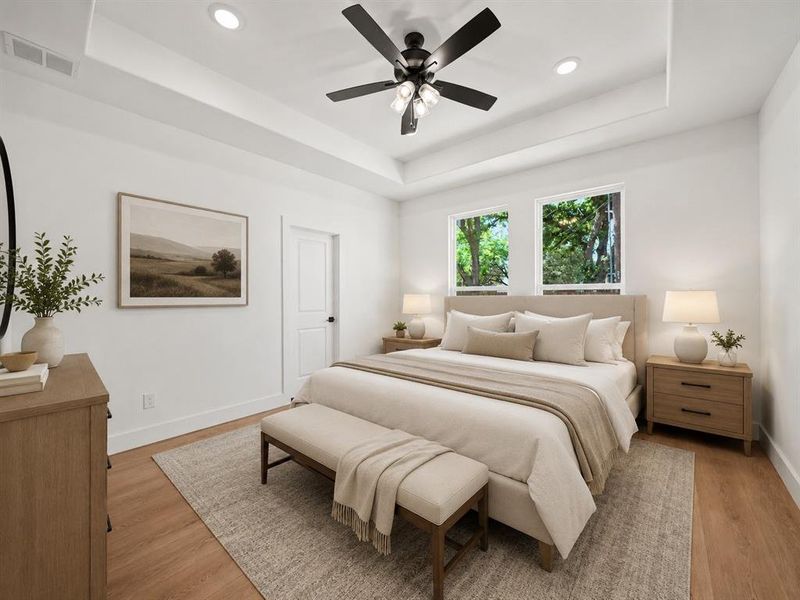 Bedroom featuring a tray ceiling with recessed lighting and a ceiling fan Bedroom featuring a tray ceiling with recessed lighting and a ceiling fan
