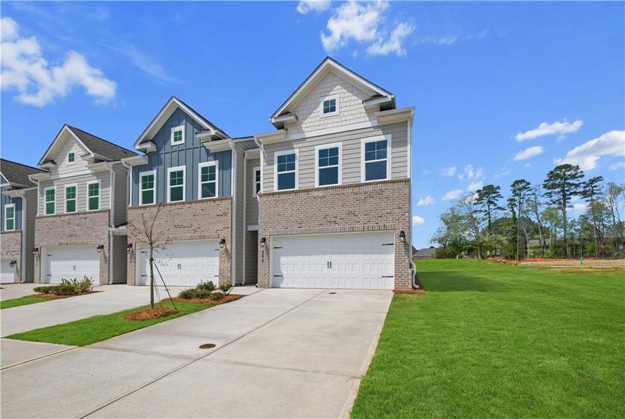 Front exterior of a new home in Langley Overlook, Loganville, GA, highlighting curb appeal (Image 1). Front exterior of a new home in Langley Overlook, Loganville, GA, highlighting curb appeal (Image 1).