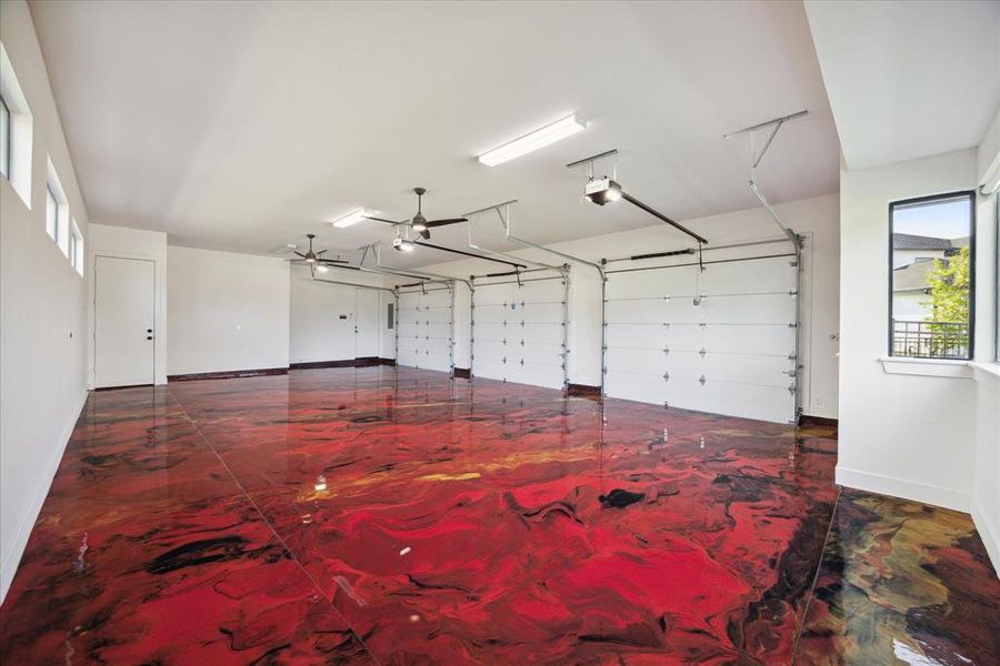 The 3-car garage is a true standout, featuring metallic shine epoxy garage flooring with an exquisite red marble flame design. This striking look not only enhances the visual appeal but also offers a durable and easy-to-maintain surface, ideal for accommodating your vehicles and extra storage. The vibrant red marble flame pattern adds a touch of sophistication, turning a conventional garage into a stylish and functional space.