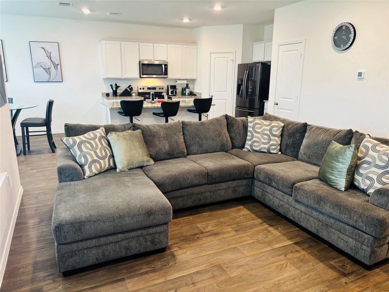Open-concept living area featuring wood-finish flooring Open-concept living area featuring wood-finish flooring