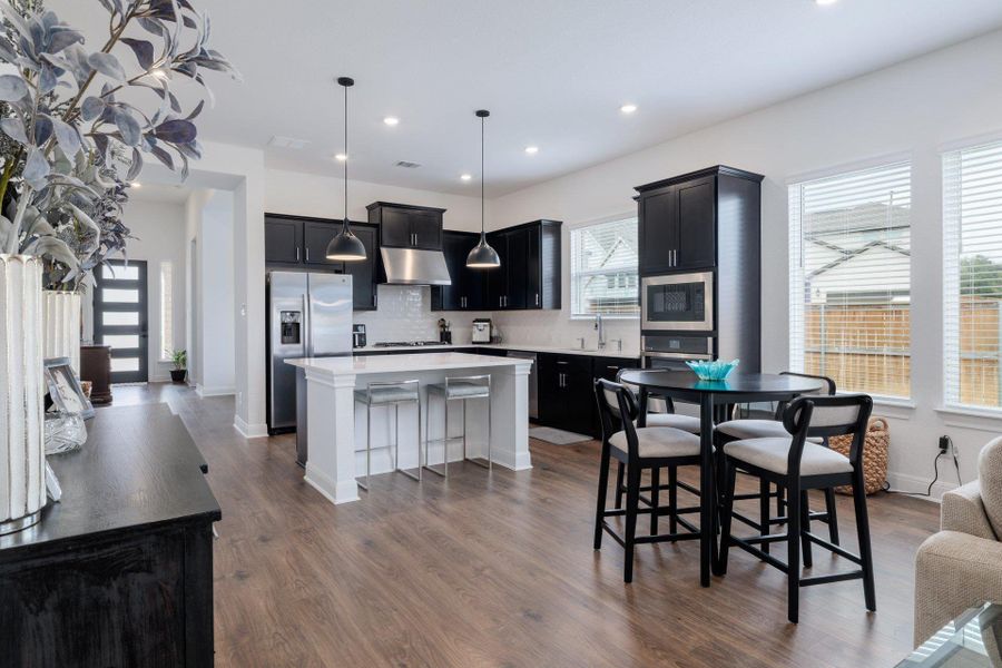 Kitchen features island seating and breakfast area. Kitchen features island seating and breakfast area.