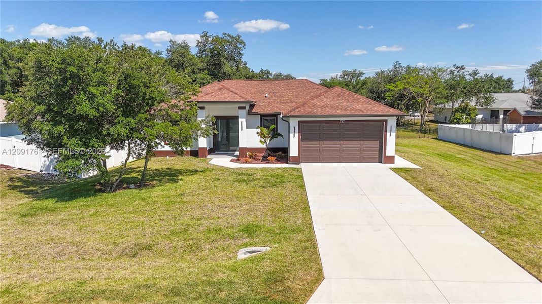 Front exterior of a new home in , Lehigh Acres, FL, highlighting curb appeal (Image 2). Front exterior of a new home in , Lehigh Acres, FL, highlighting curb appeal (Image 2).