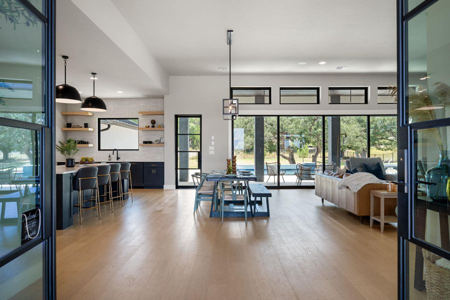 Gleaming hardwood floors and a wall of glass doors define this expansive open layout.