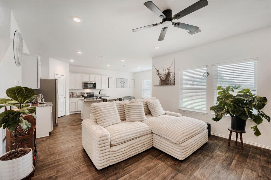 Open-concept living space featuring wood-finish flooring and recessed lighting Open-concept living space featuring wood-finish flooring and recessed lighting