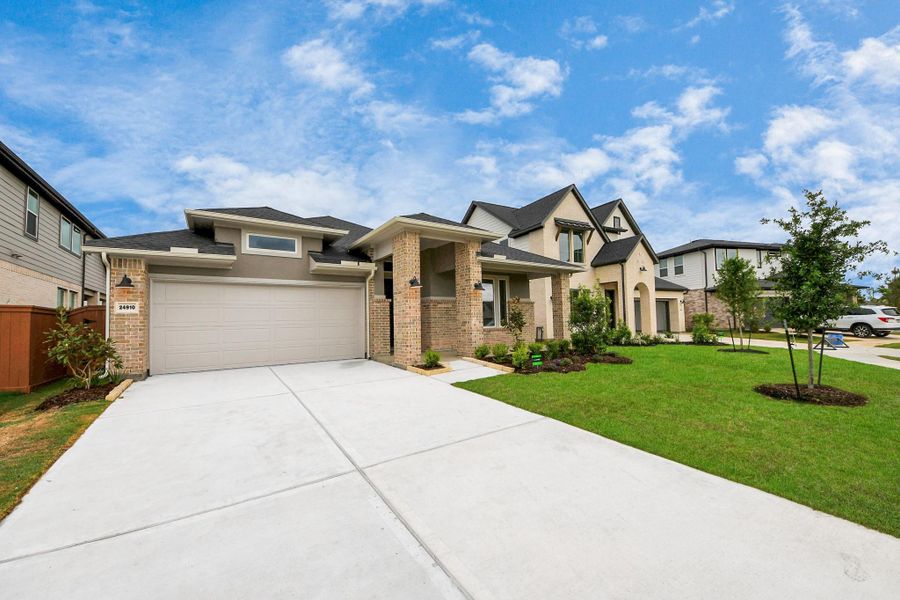 Front exterior of a new home in 50' Traditional Homes at Elyson, Katy, TX, highlighting curb appeal (Image 23). Front exterior of a new home in 50' Traditional Homes at Elyson, Katy, TX, highlighting curb appeal (Image 23).