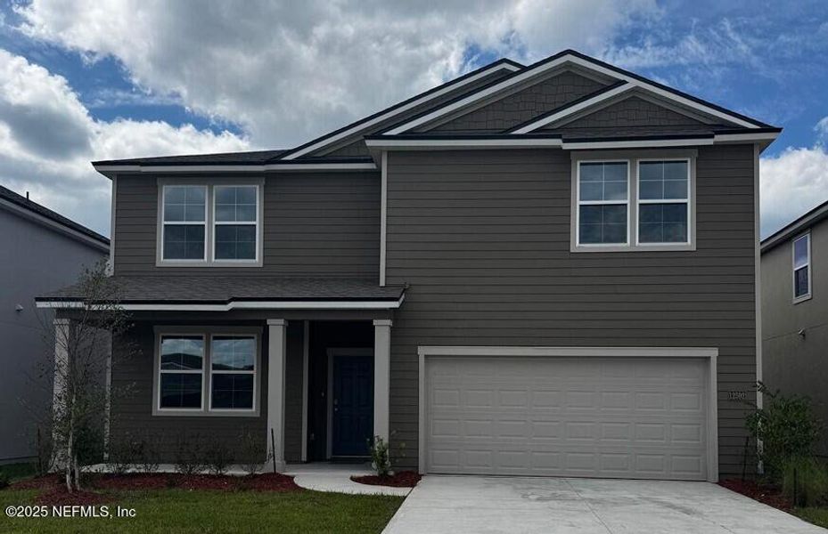 Front exterior of a new home in The Arbors, Jacksonville, FL, highlighting curb appeal (Image 18).