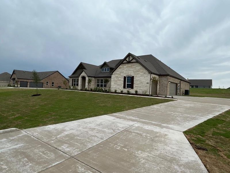 Front exterior of a new home in Creekview Addition, Van Alstyne, TX, highlighting curb appeal (Image 15).