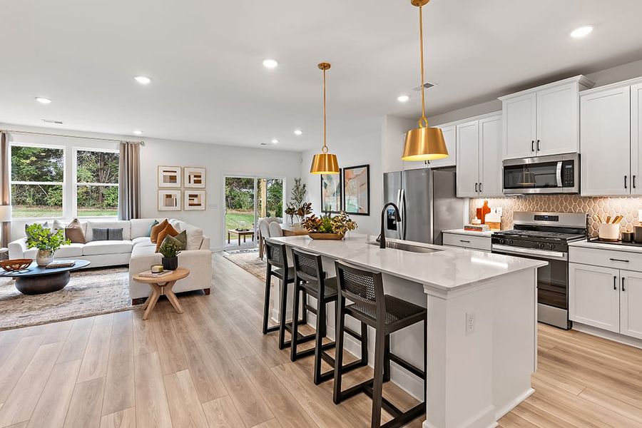 A kitchen with a wood floor. A kitchen with a wood floor.