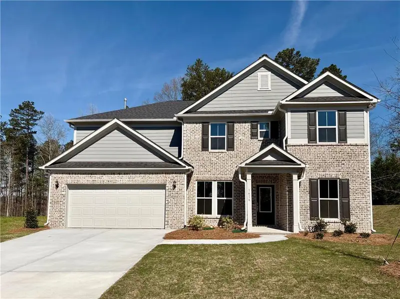 Front exterior of a new home in Riversprings, Dacula, GA, highlighting curb appeal (Image 2). Front exterior of a new home in Riversprings, Dacula, GA, highlighting curb appeal (Image 2).