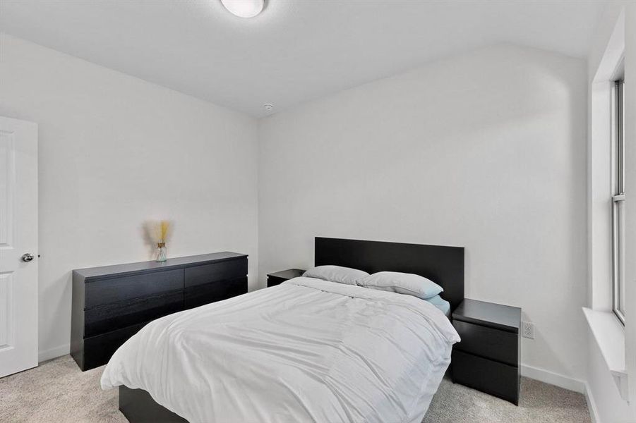 Bedroom with light carpet and baseboards Bedroom with light carpet and baseboards