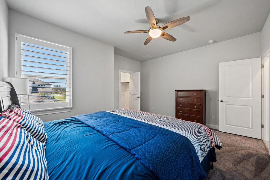 Bedroom featuring ceiling fan and carpet floors